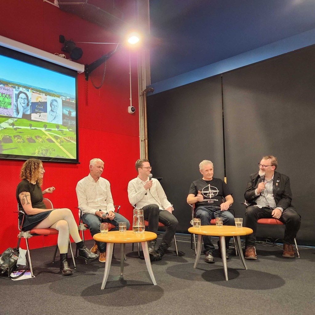 Author panel with five panellists sitting on stage