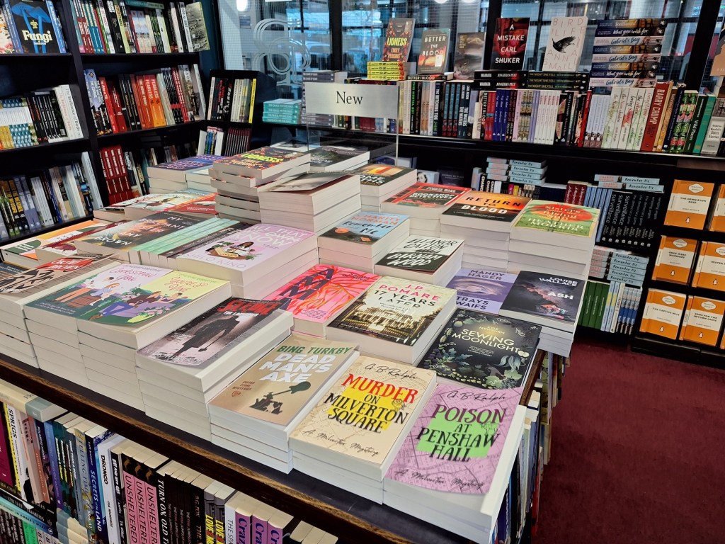 New book table featuring paperback copies of The Milverton Mysteries. Photo taken in Bruce McKenzie Booksellers of Palmerston North, New Zealand.
