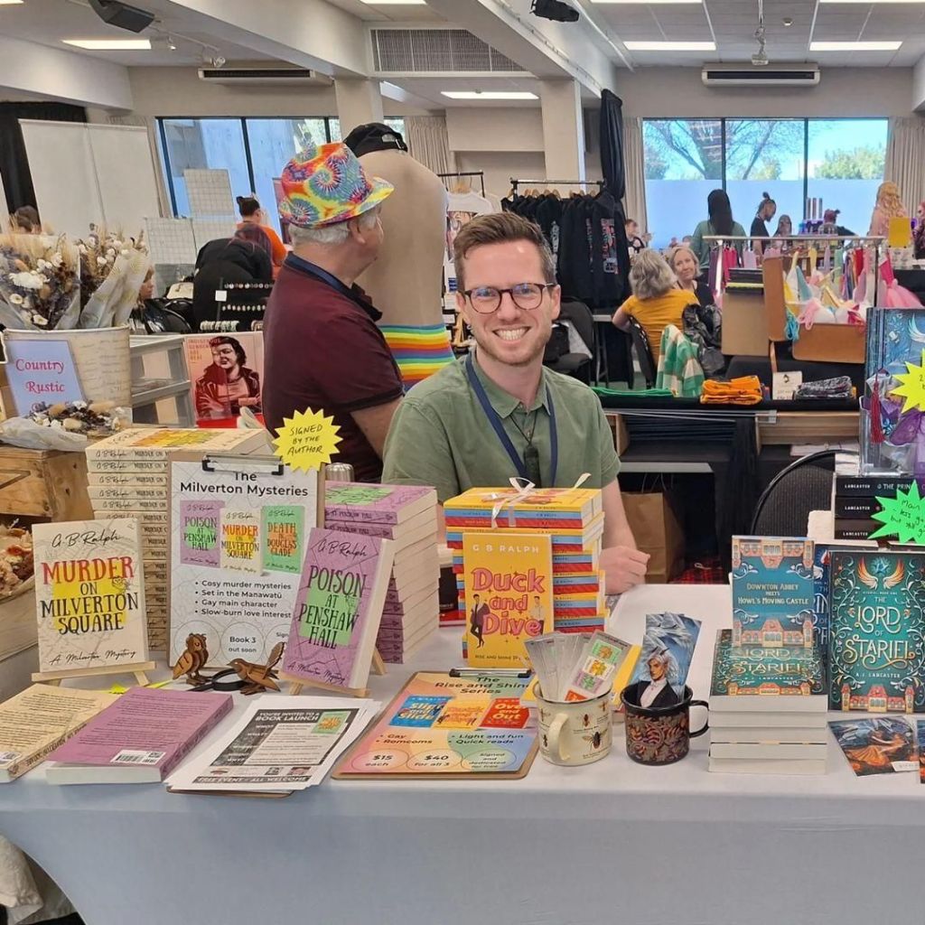 Author G B Ralph with his books at a stall at the Palmy Drag Fest Rainbow Fair