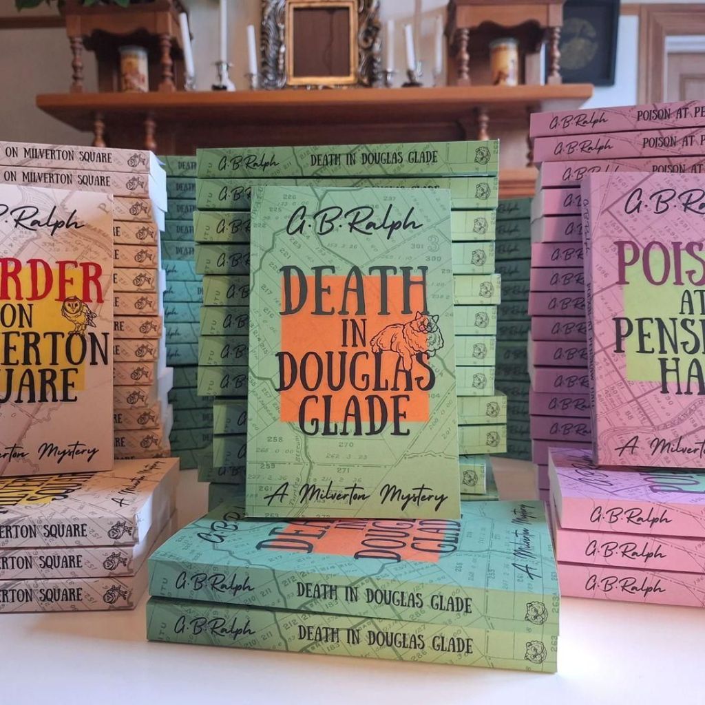 Stacks of books centred on Death in Douglas Glade by G B Ralph.