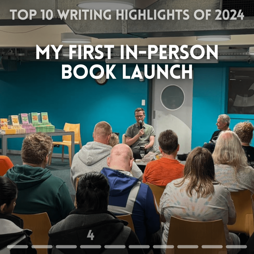 Top 10 writing highlights of 2024. My first in-person book launch. Photo of author G B Ralph holding a microphone in front of an audience.