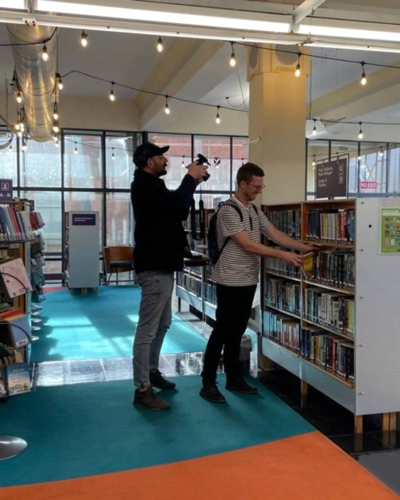 Being filmed pulling a book off the shelf