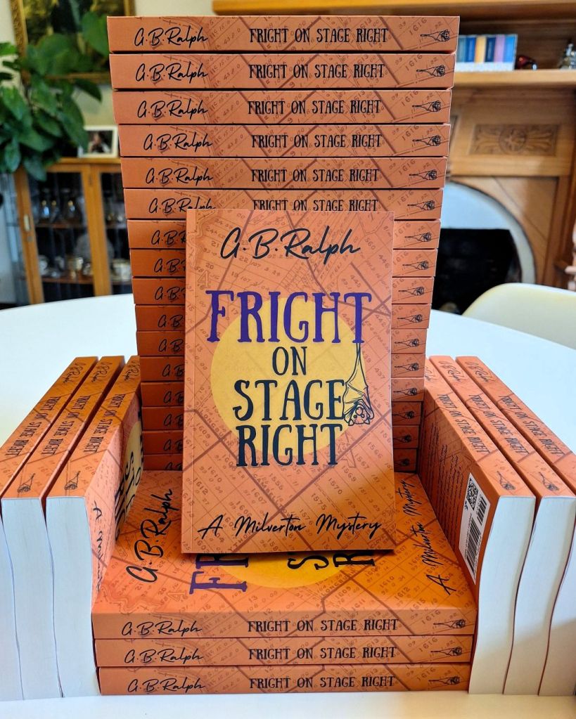 Stack of paperback copies of Fright on Stage Right by G. B. Ralph arranged in the shape of a throne.
