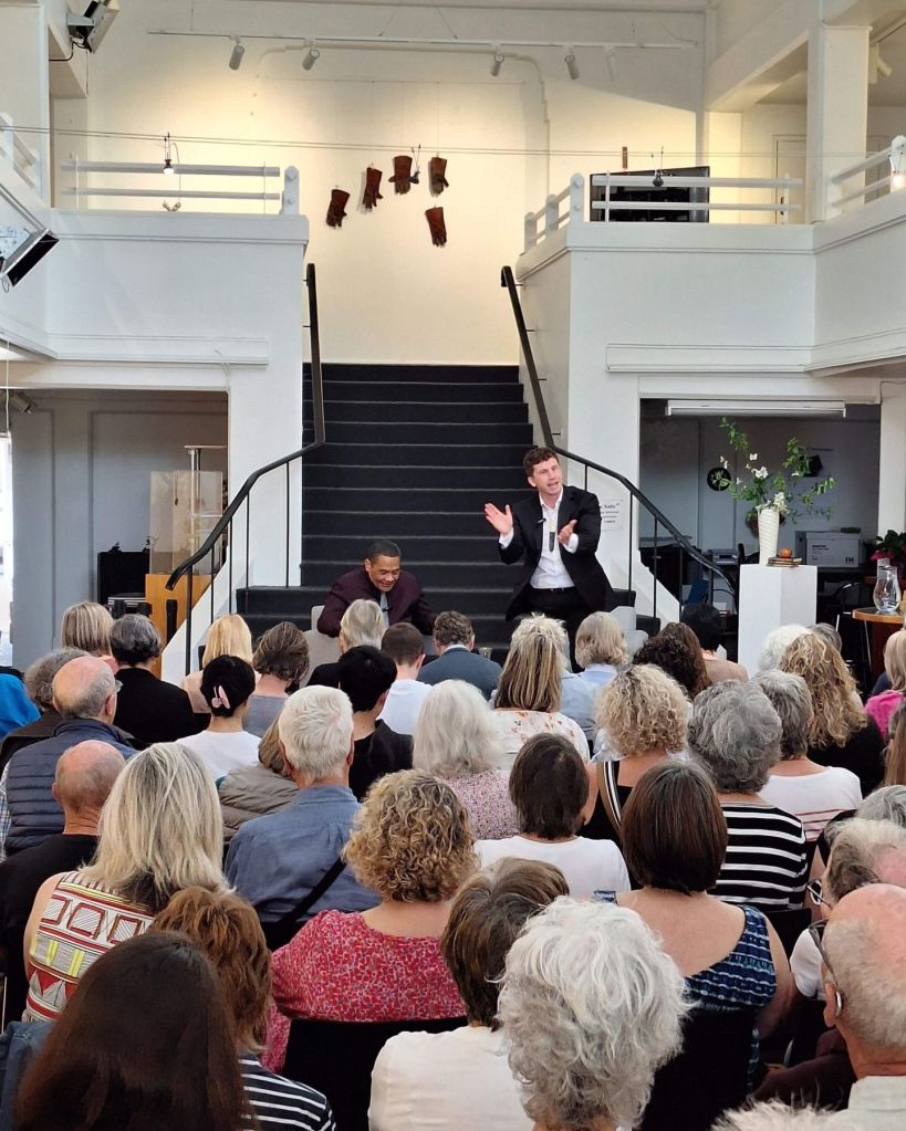 A panellist and chairperson on stage