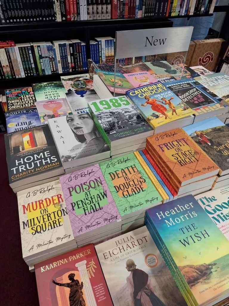 Bookshop display table featuring books including The Milverton Mysteries by G. B. Ralph